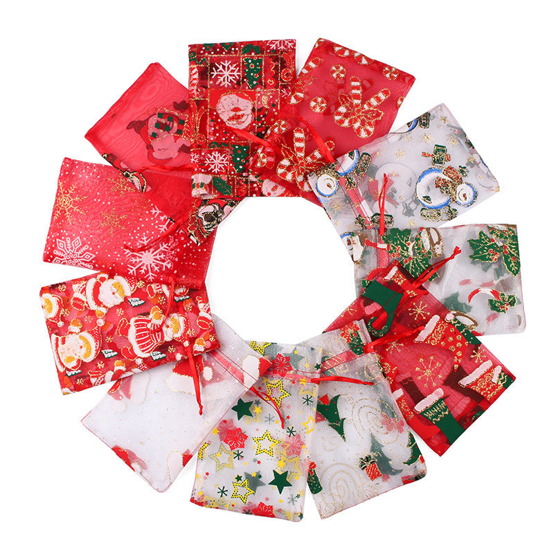Sheer organza Christmas gift bags with red ribbon ties and festive print