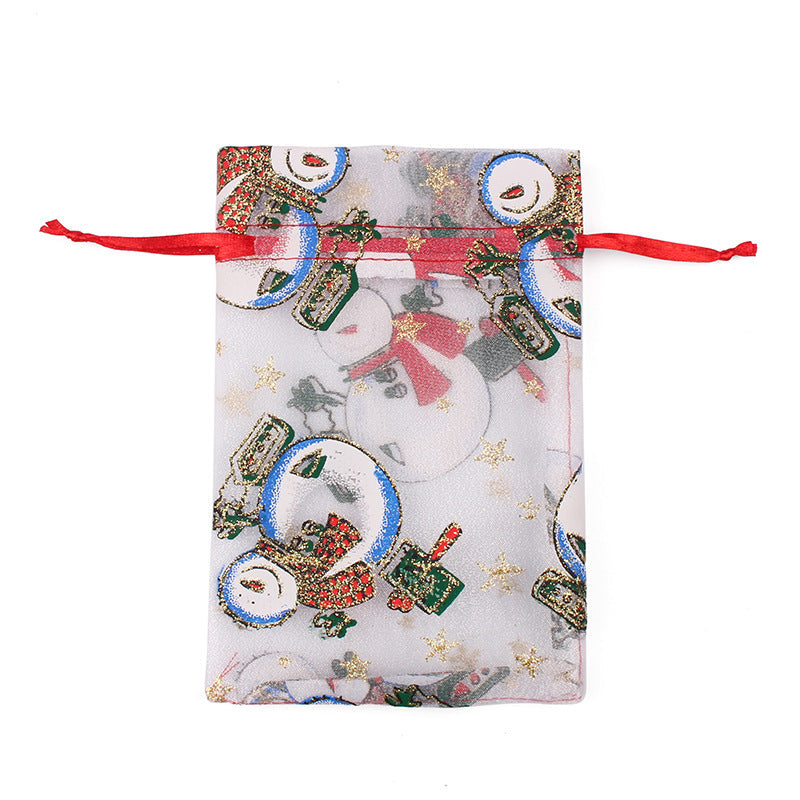 Sheer organza Christmas gift bags with red ribbon ties and festive print