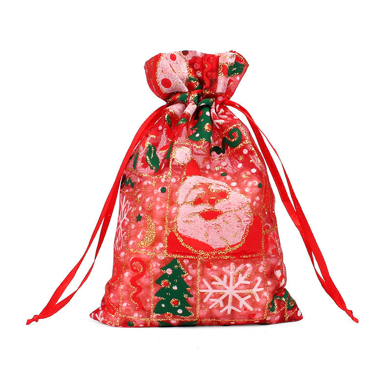 Sheer organza Christmas gift bags with red ribbon ties and festive print