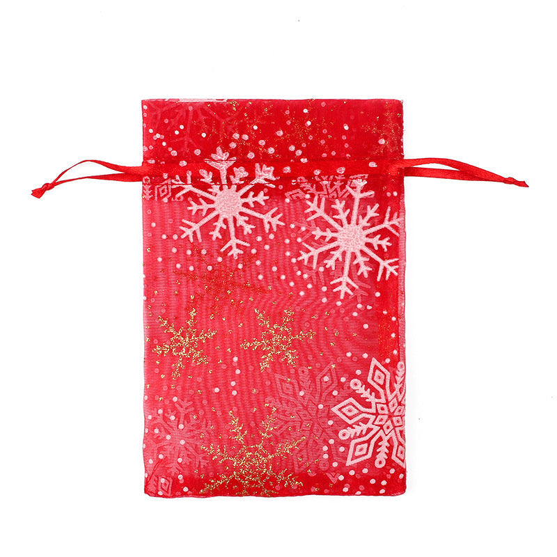 Sheer organza Christmas gift bags with red ribbon ties and festive print