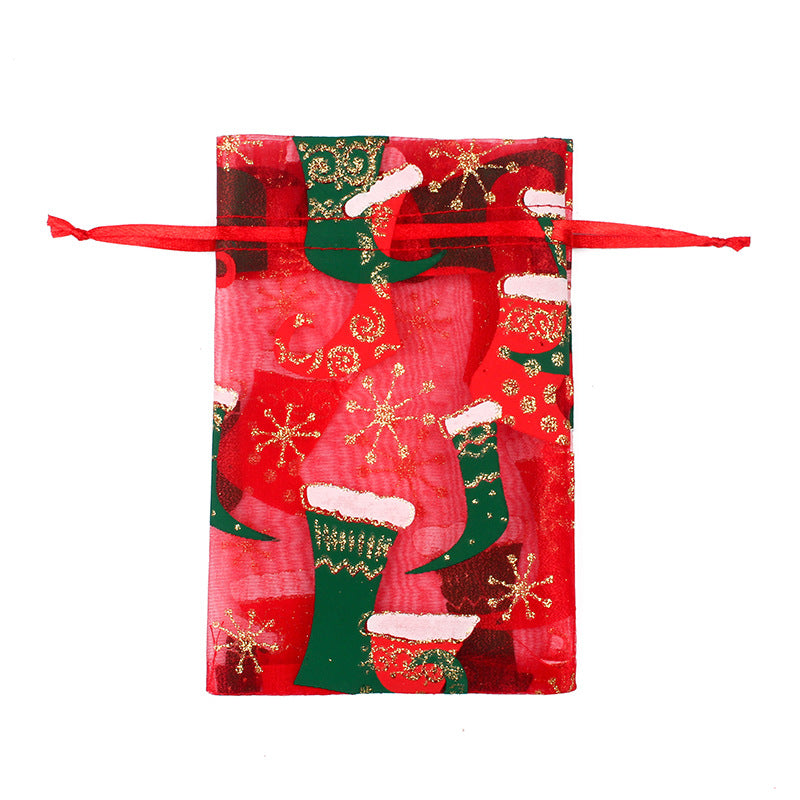 Sheer organza Christmas gift bags with red ribbon ties and festive print