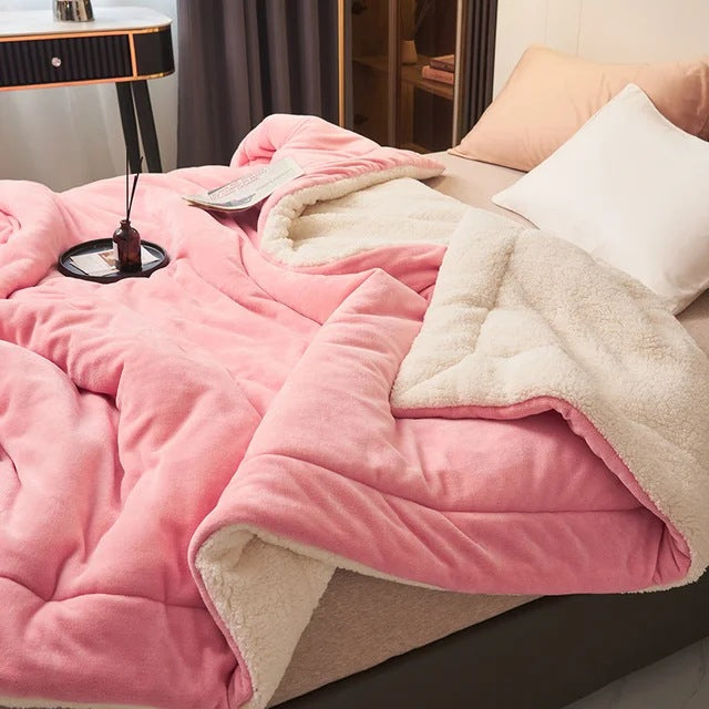 Sherpa blanket with quilted channels on a made bed - pink