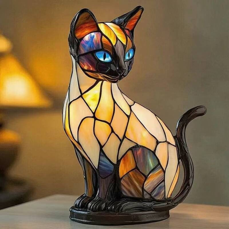 Siamese cat lamp in a stained glass look with a cream body, dark head and ears and blue eyes