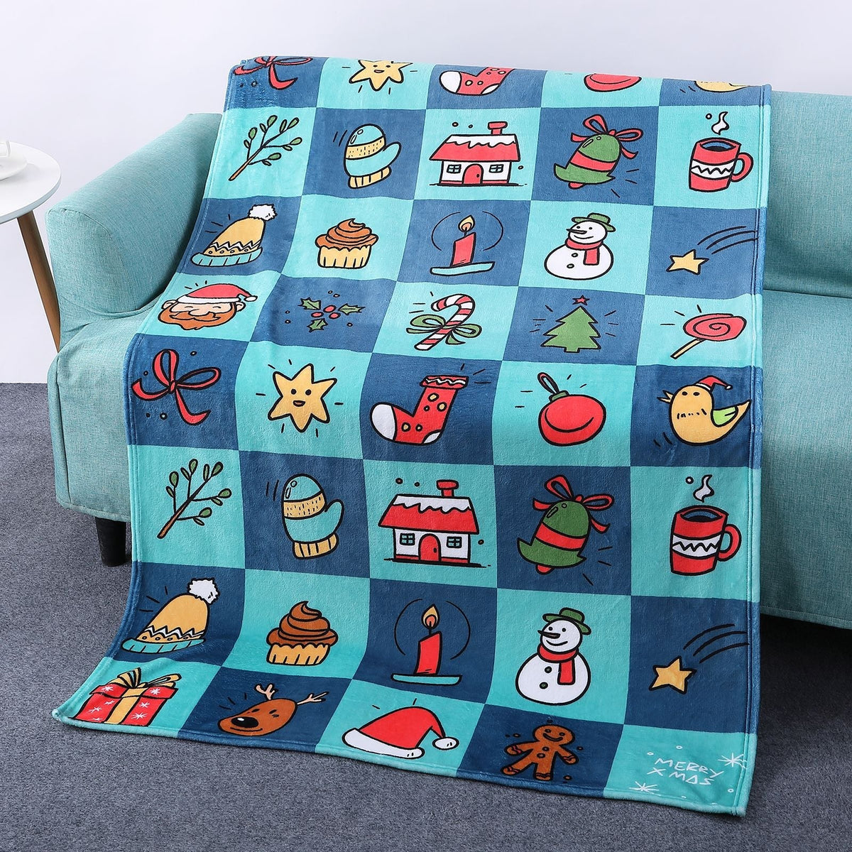 Soft Christmas blanket with a festive print, draped over a sofa - teal christmas icons
