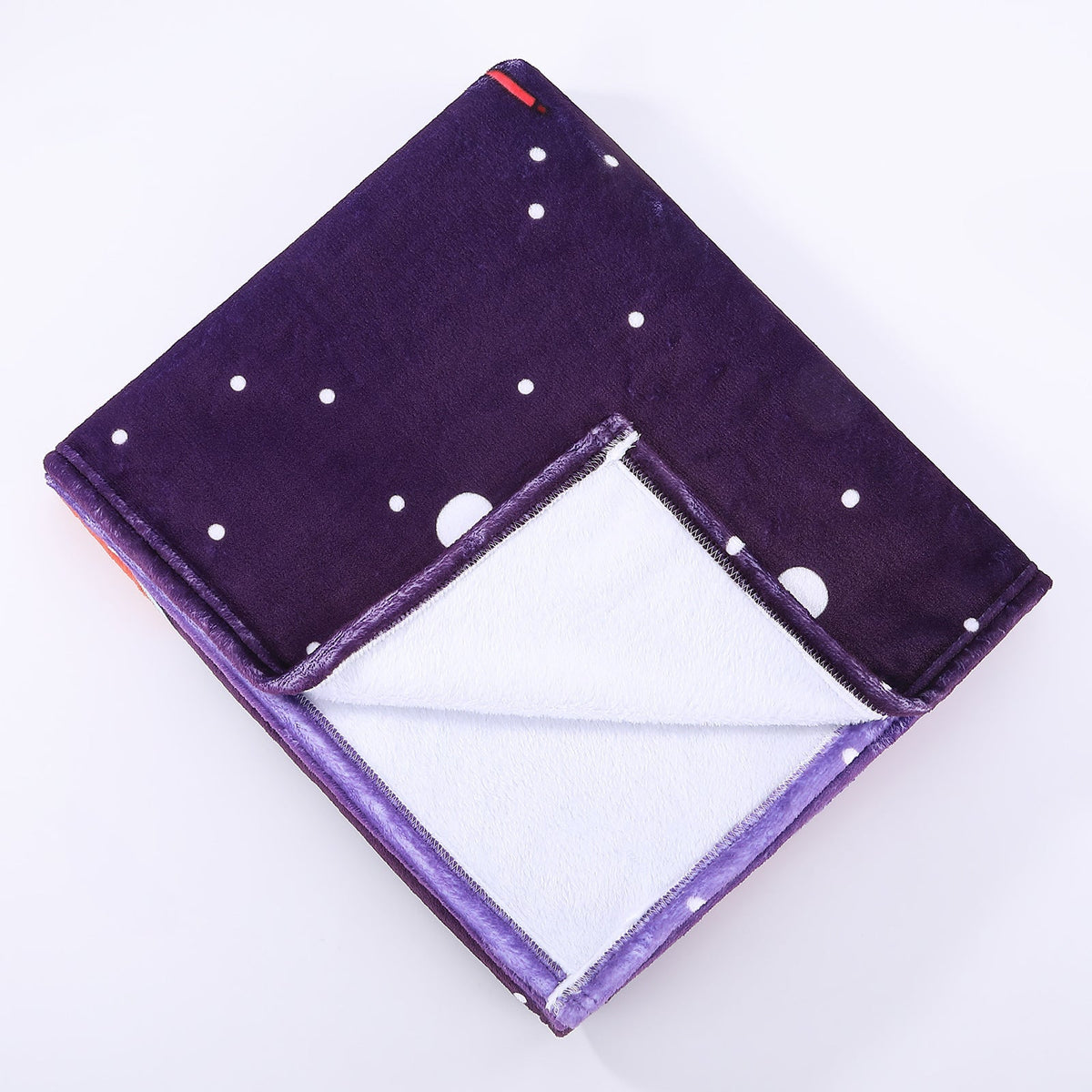 Soft Christmas blanket with a festive print, draped over a sofa
