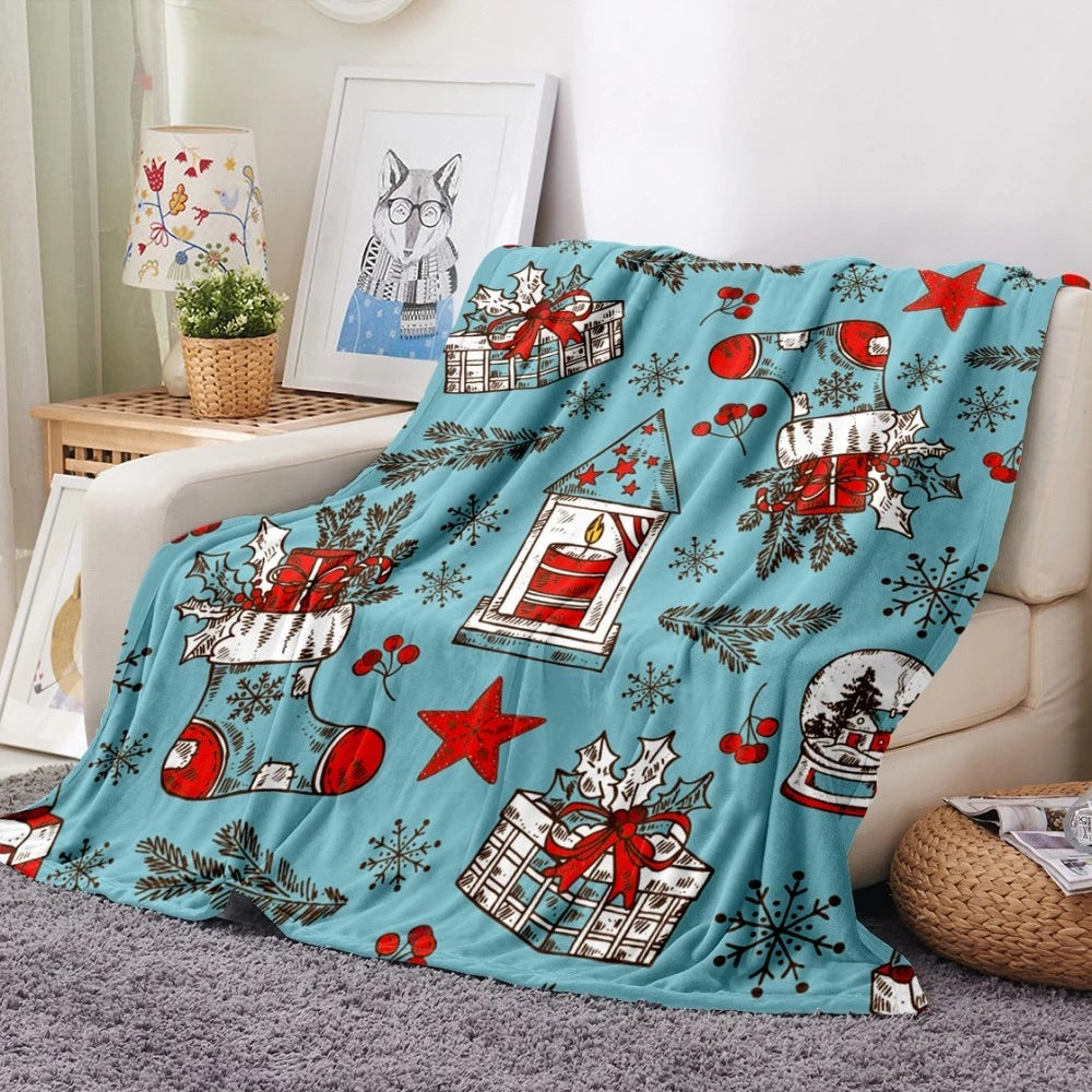 Soft fleece Christmas blanket with an all-over festive print on a sofa - light blue presents