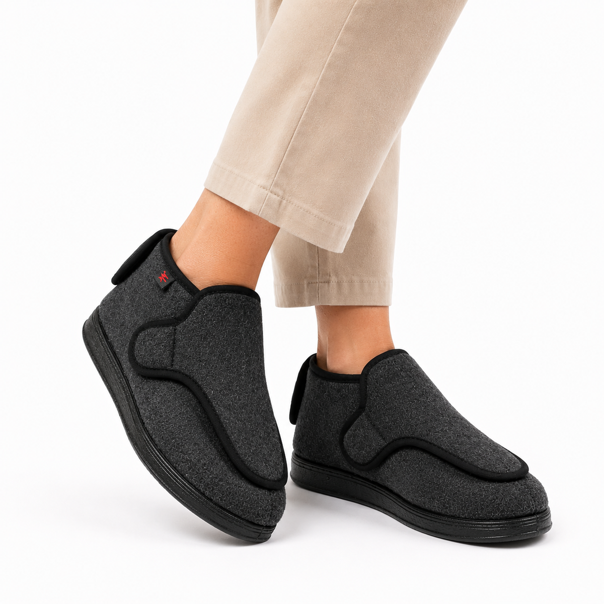Wide-fit house shoes with an adjustable wrap-over strap and a pull tab