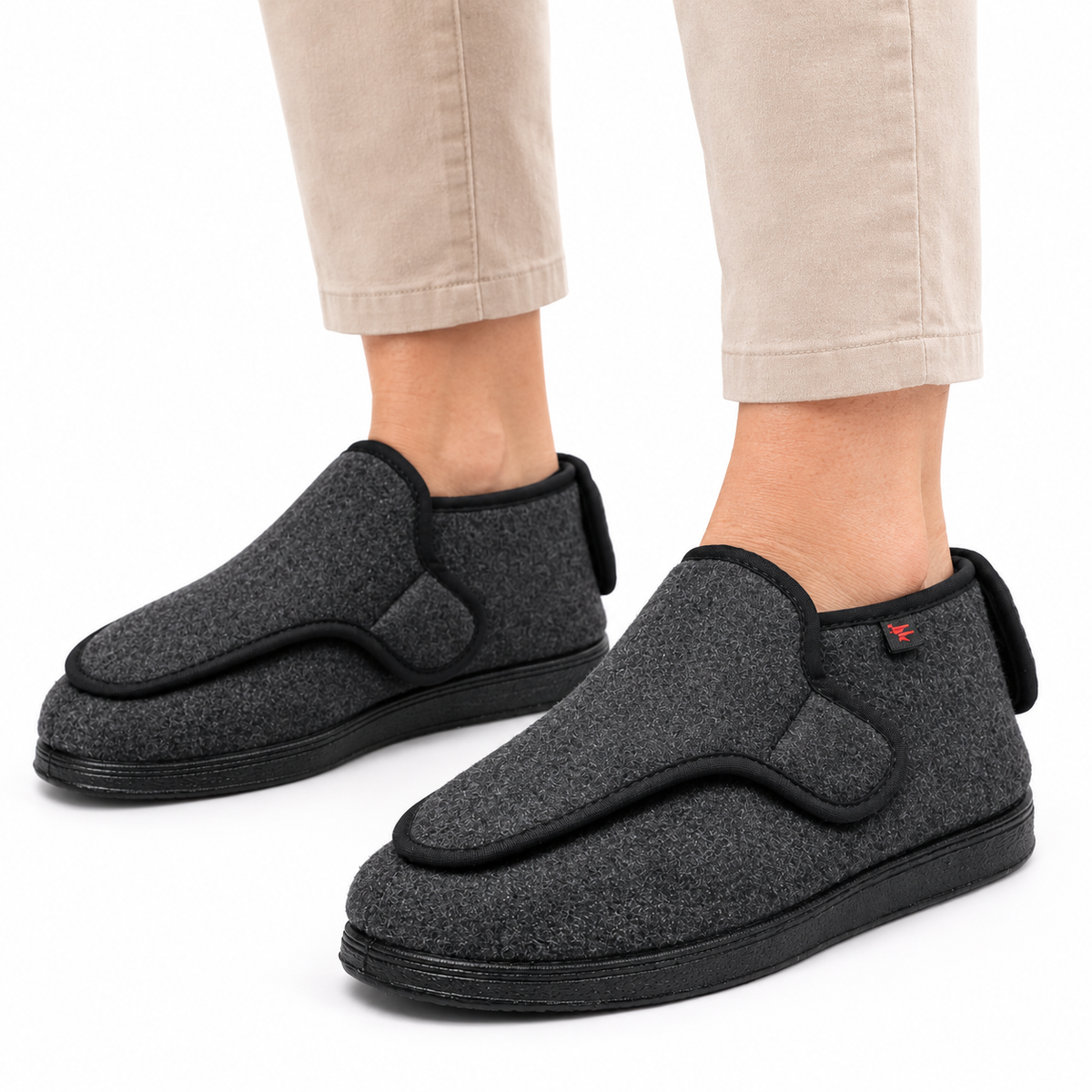 Wide-fit house shoes with an adjustable wrap-over strap and a pull tab