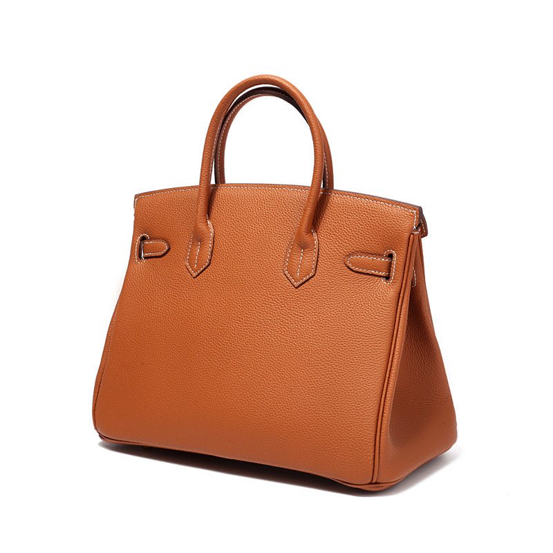 Structured top handle bag with two rolled handles, a flap with turn lock and a padlock