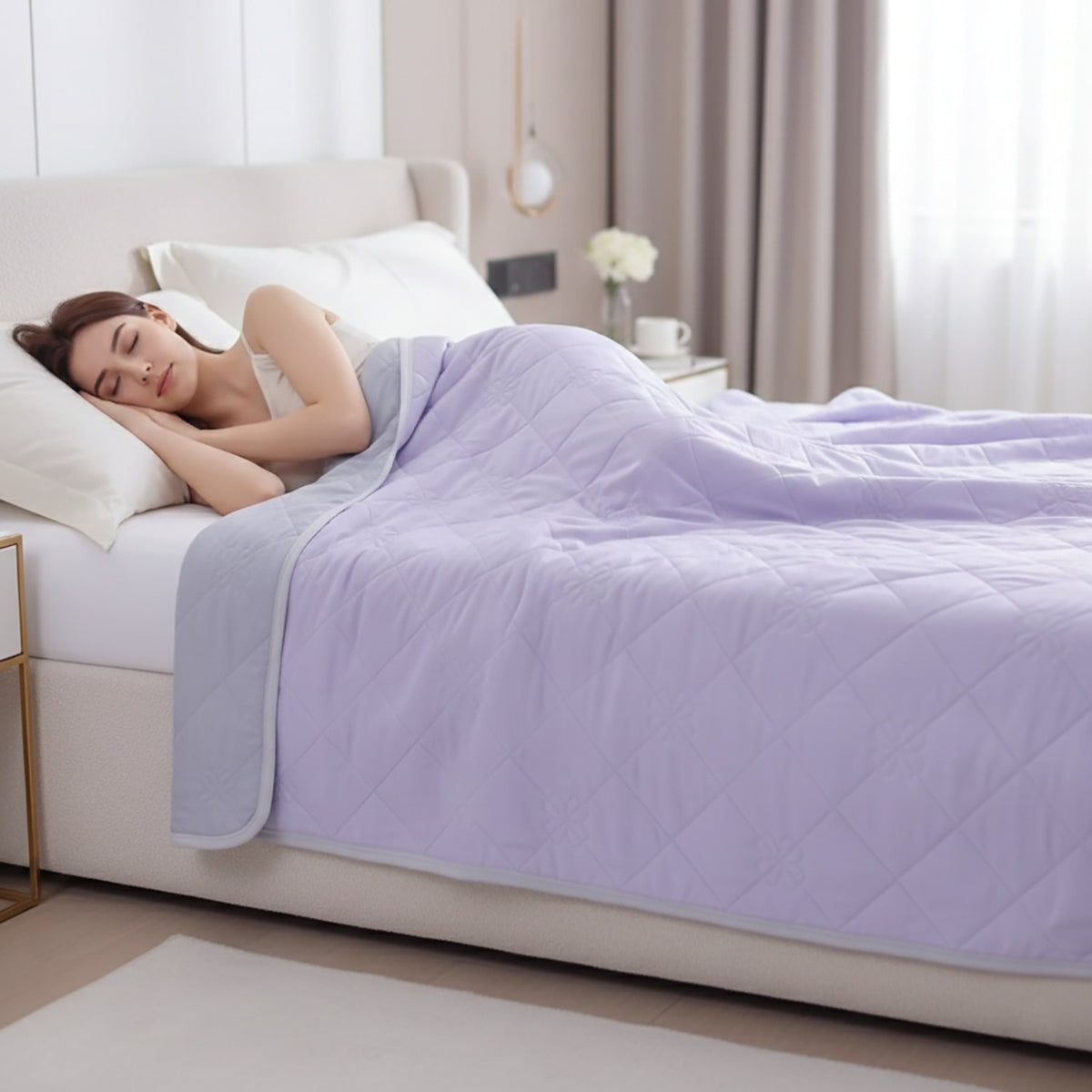 Reversible summer blanket with diamond and floral stitching on a bed