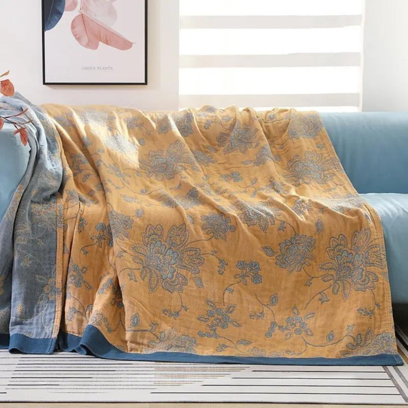 Summer blanket with a jacquard floral pattern over a sofa - ochre yellow