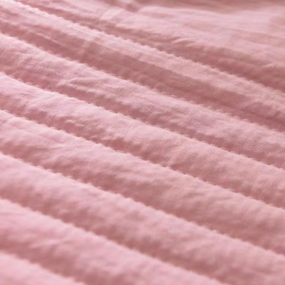 Thin quilted summer blanket with piping on a made bed - view 5
