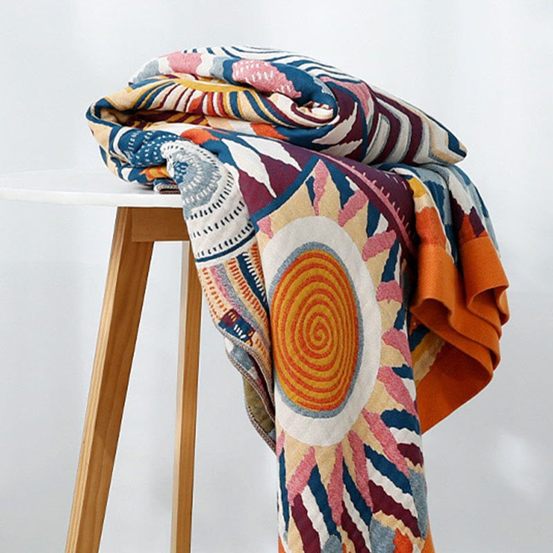 Woven throw with a colourful sun pattern and an orange border - view 6