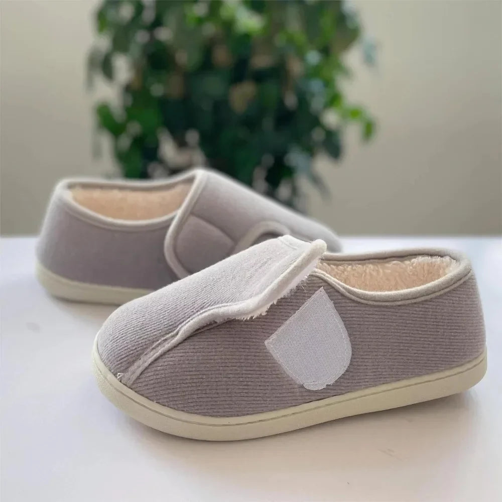 Extra-wide unisex slippers with an adjustable strap and a plush lining