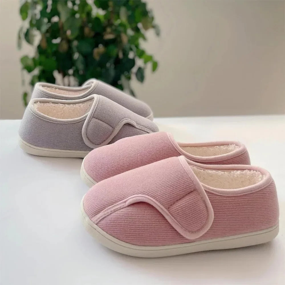 Extra-wide unisex slippers with an adjustable strap and a plush lining