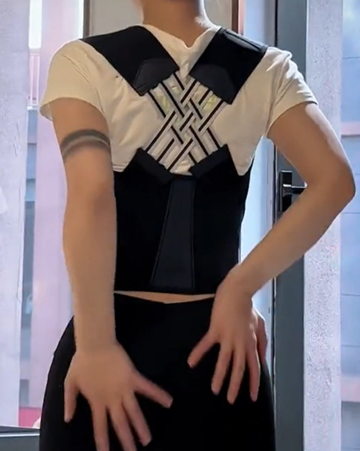 Waist cincher with a hook-and-loop front and shoulder straps that cross over the back - black