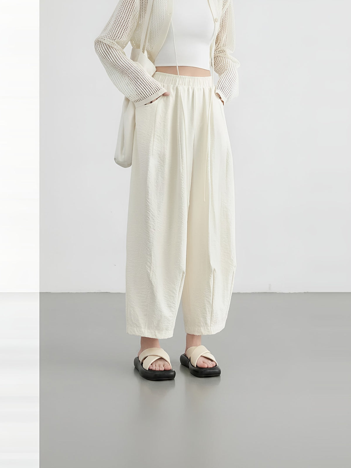 Women's cream wide-leg trousers with pleats and an elasticated waist, front