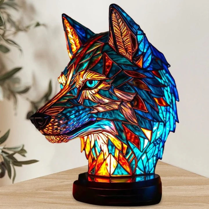 Wolf head lamp in a stained glass look in blue and orange with light blue eyes on a round base