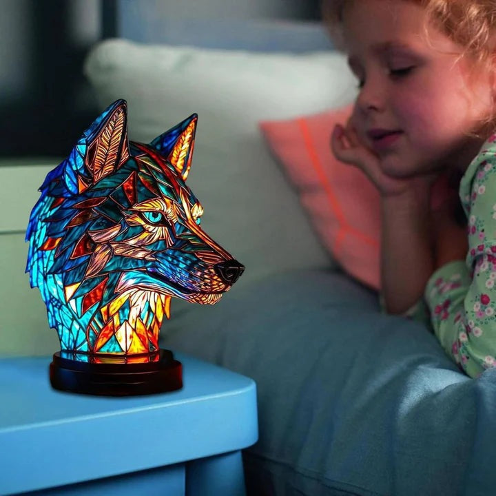 Wolf head lamp in a stained glass look in blue and orange with light blue eyes on a round base