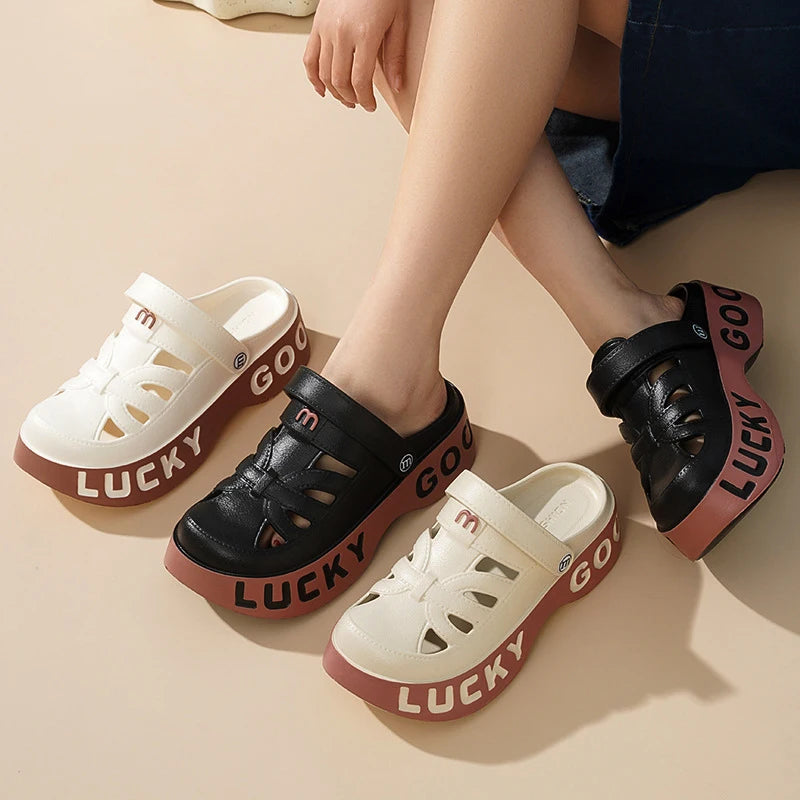 Closed-toe sliders with cut-outs, pivoting heel strap and thick platform sole with lettering