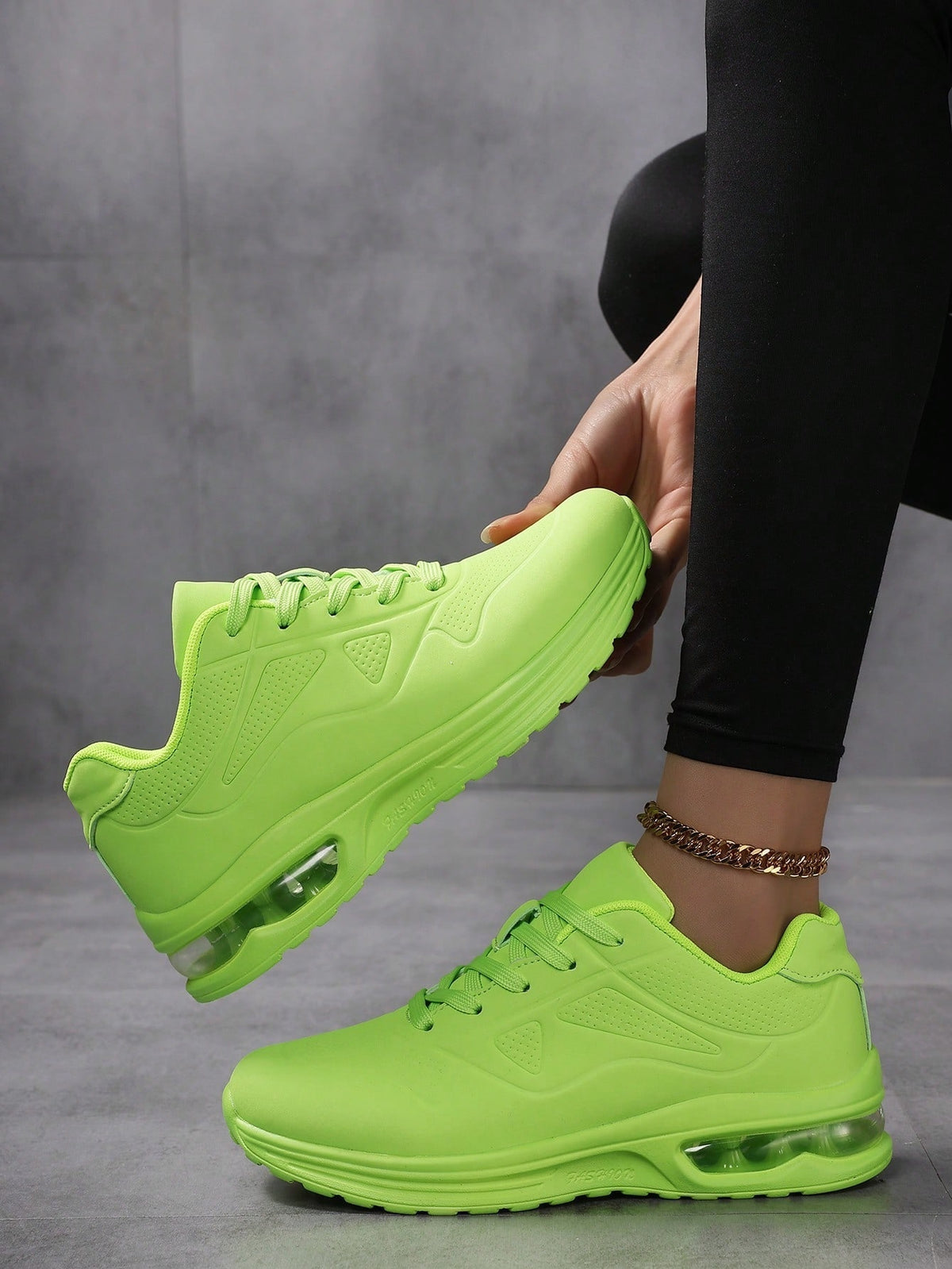 Faux leather lace-up trainers for women with chunky tread and visible air cushion in the heel - neon green