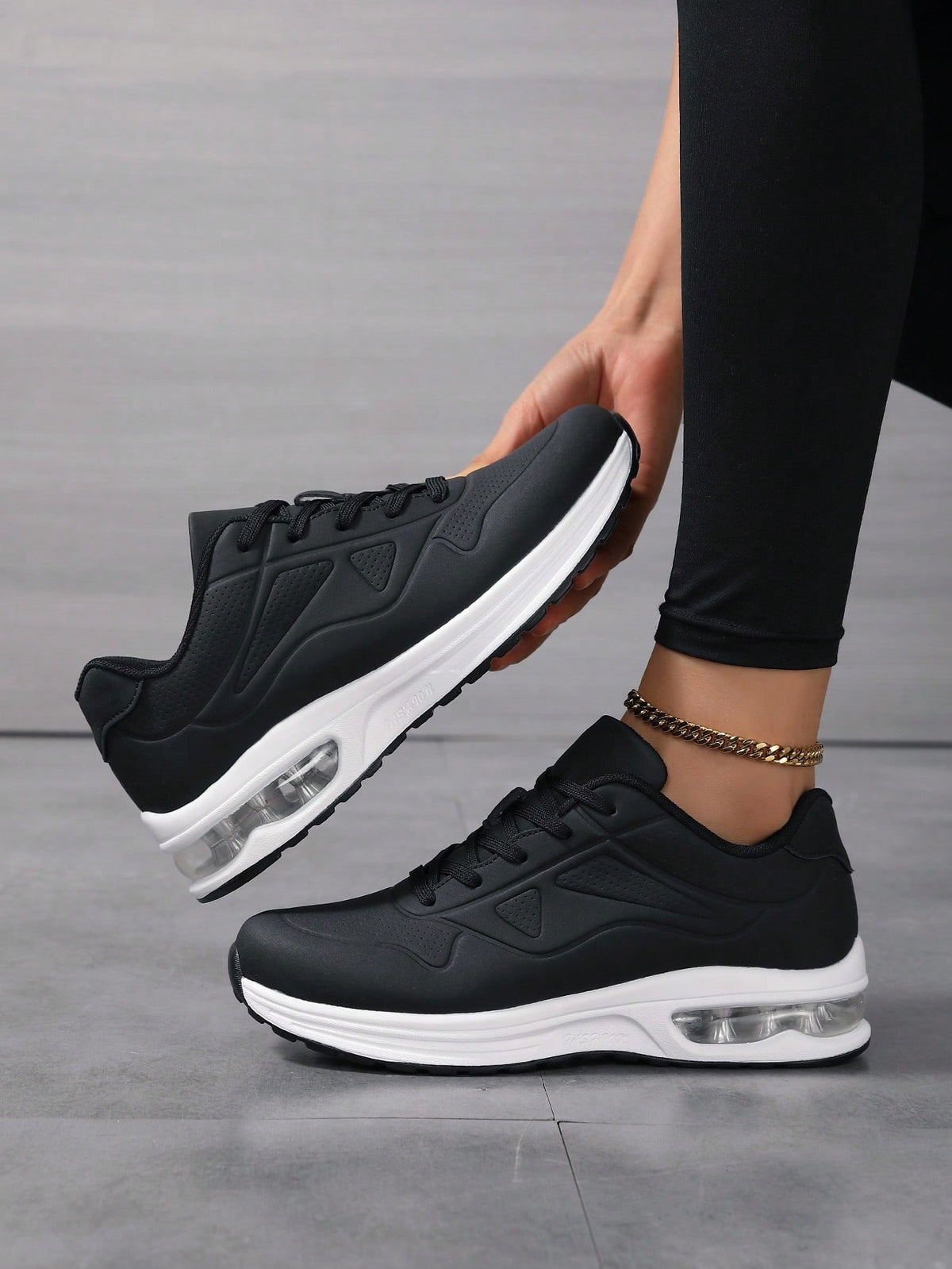 Faux leather lace-up trainers for women with chunky tread and visible air cushion in the heel - black