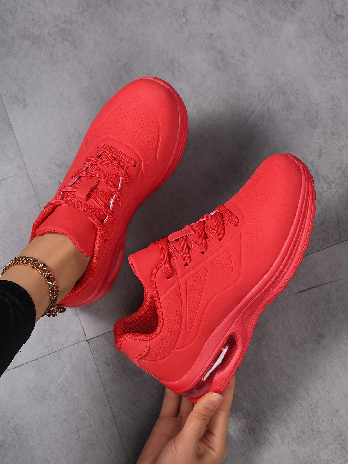 Faux leather lace-up trainers for women with chunky tread and visible air cushion in the heel - red