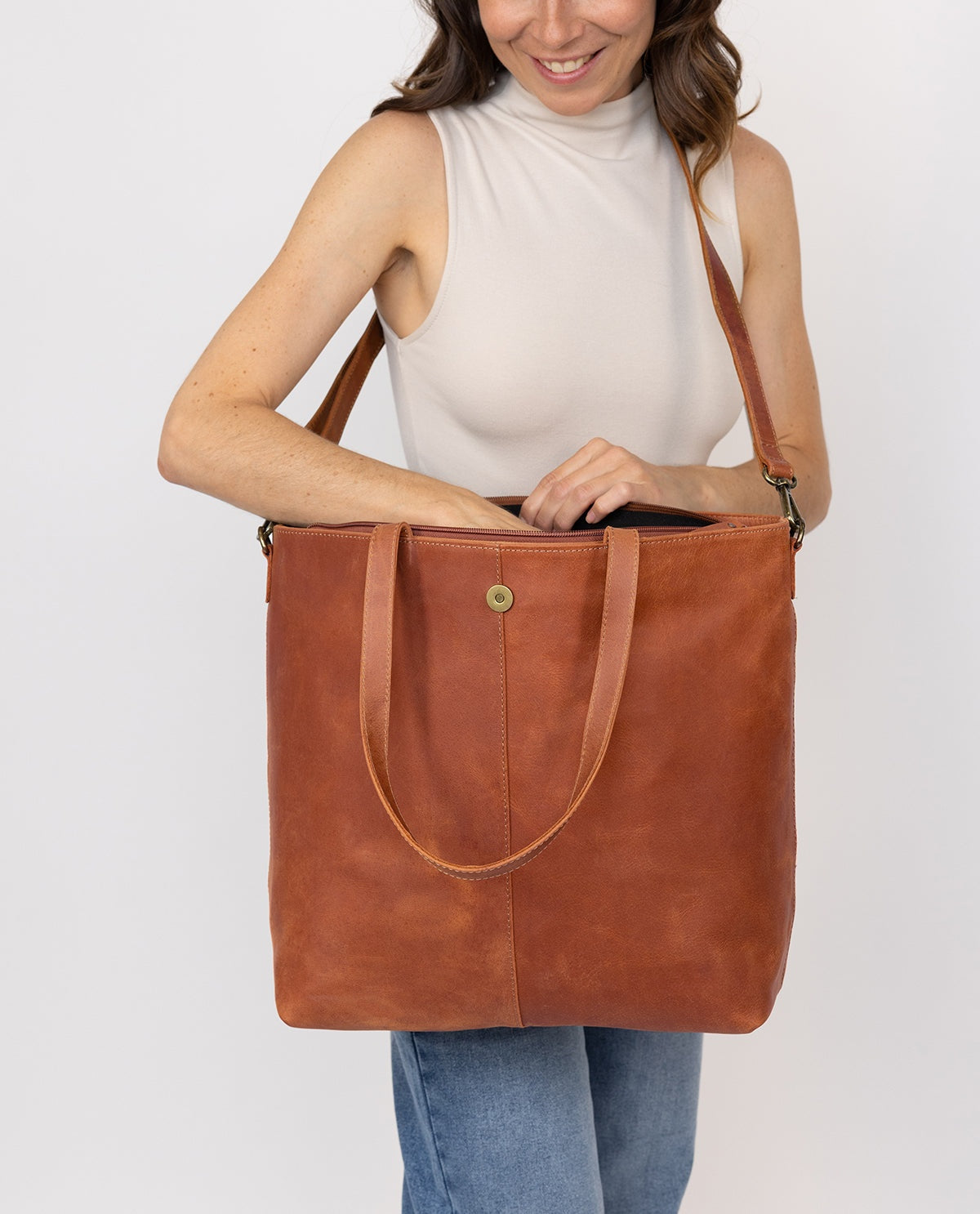 Women's brown leather tote bag with short handles and a detachable shoulder strap