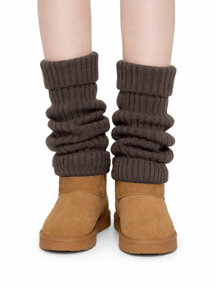 Women's ribbed knit leg warmers with a fold-over cuff, worn over boots - brown
