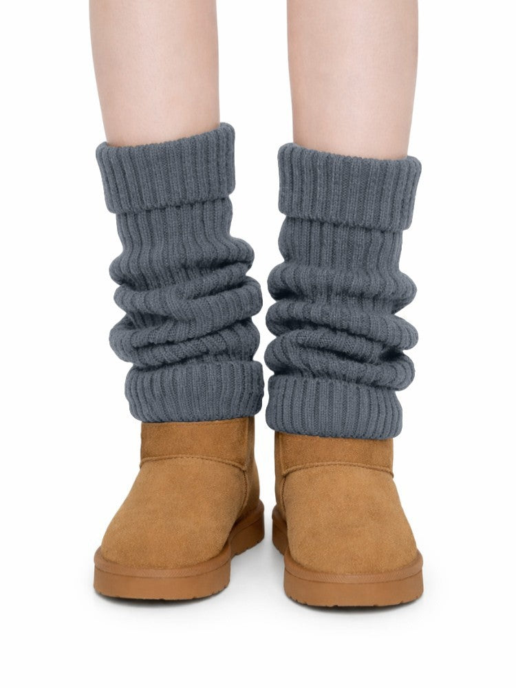 Women's ribbed knit leg warmers with a fold-over cuff, worn over boots - dark grey