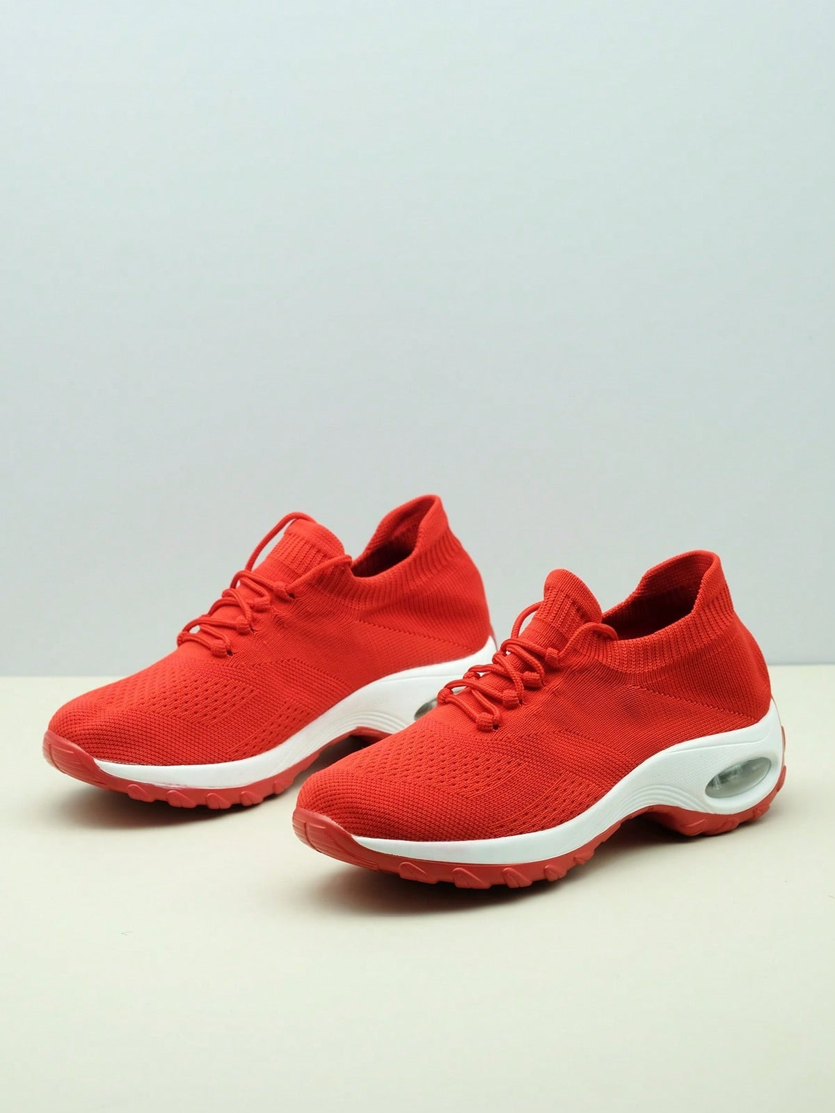 Slip-on trainers for women with knit sock collar, decorative laces and thick air cushion sole - red