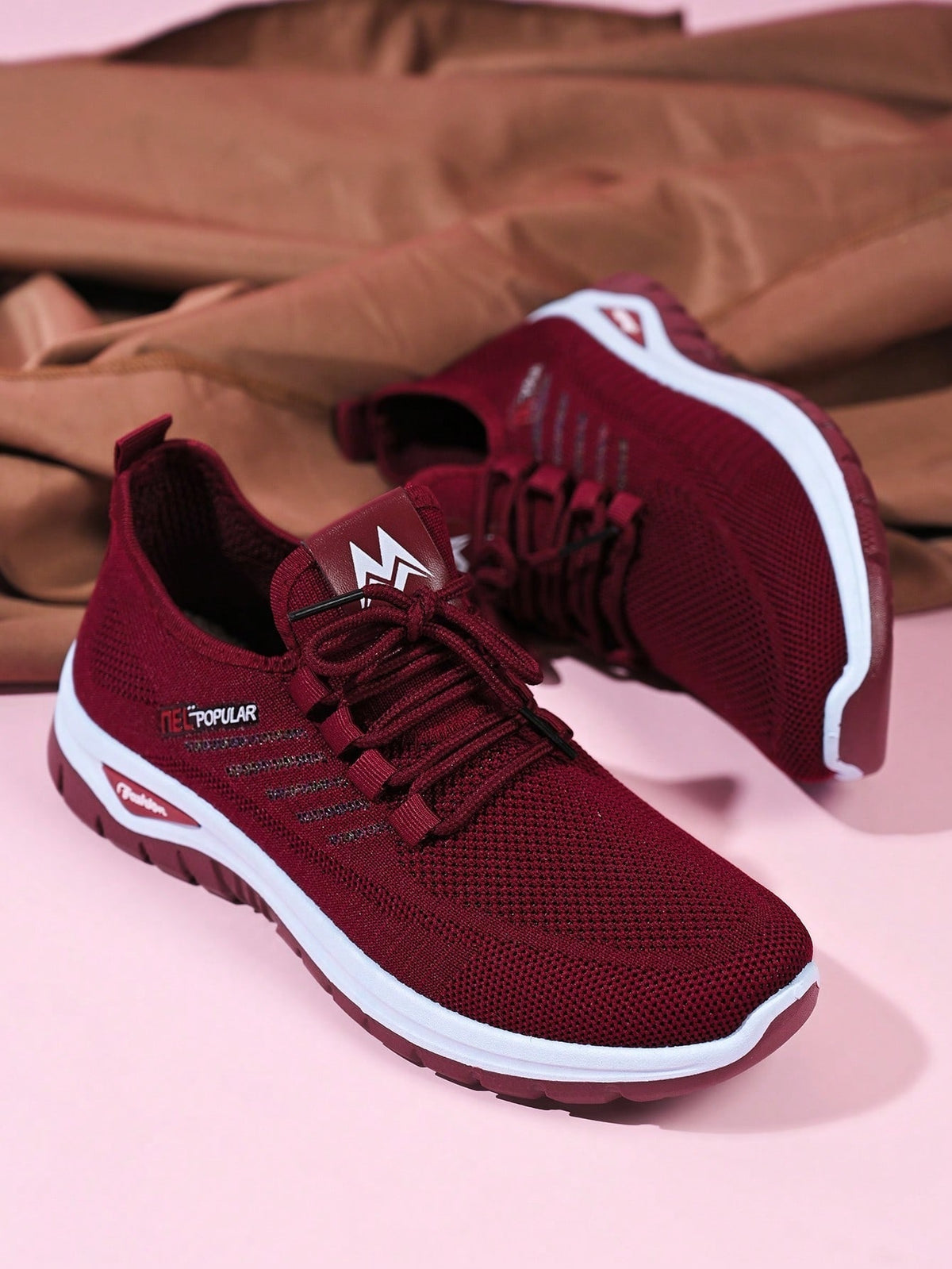 Knit trainers for women with elastic laces, small emblem on the tongue and thick curved sole - burgundy