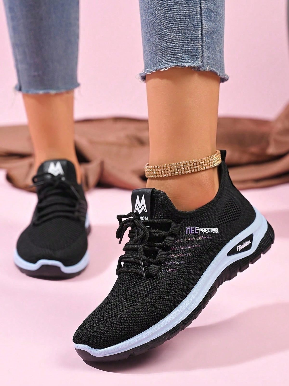 Knit trainers for women with elastic laces, small emblem on the tongue and thick curved sole - black
