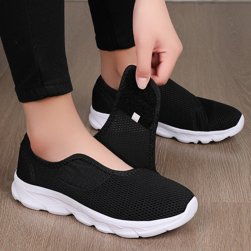 Wide fit mesh shoes for women with broad hook and loop strap over the instep and flat tread sole - black/white