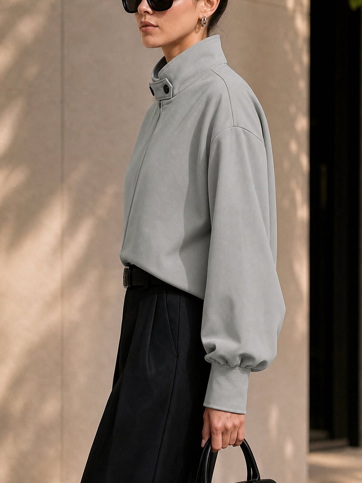 Oversized grey jacket with a high stand collar and zip front