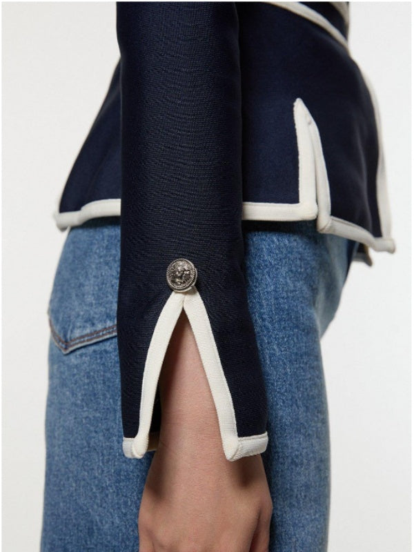 Navy jacket with cream contrast piping, a round neck and zip front