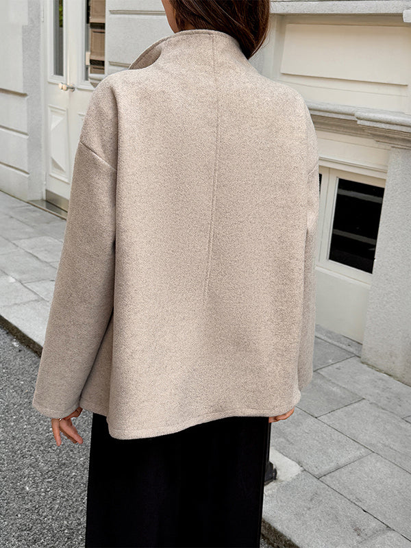 Short beige coat with a stand collar and two rows of buttons