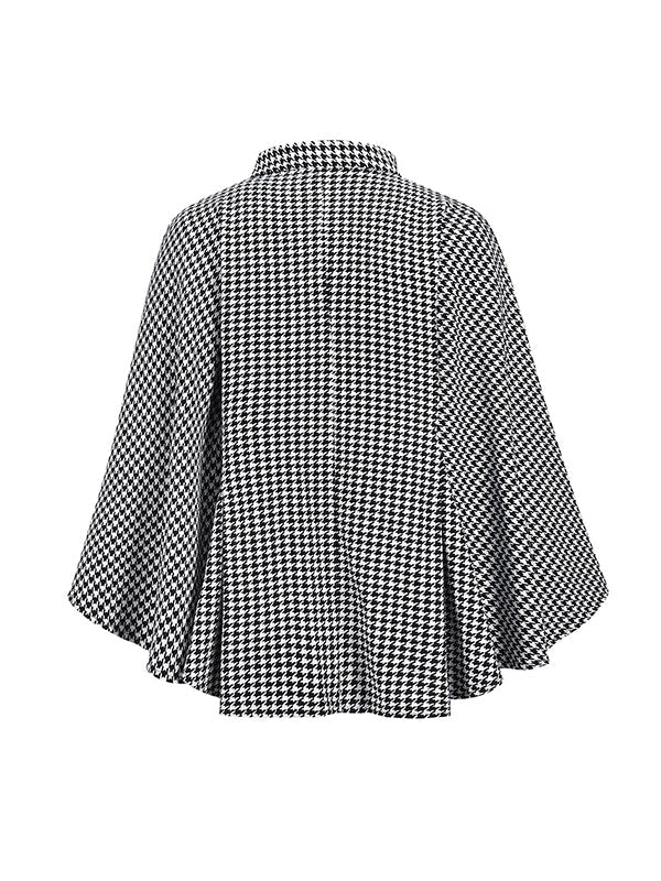Black and white houndstooth cape coat with a stand collar and tie belt