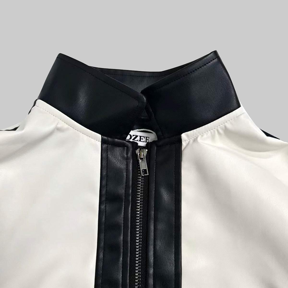 Cropped cream bomber jacket with black contrast panels and a zip front