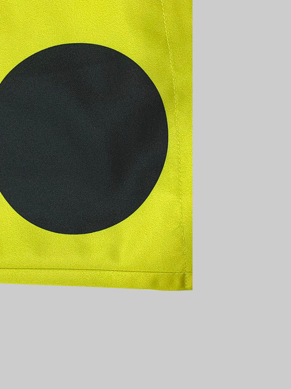 Yellow longline coat with large black polka dots and a round neck