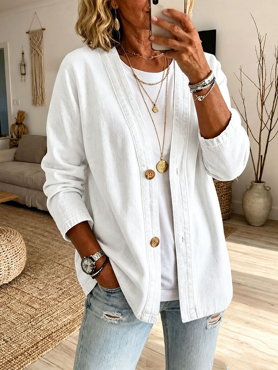 Collarless denim jacket with a button front and dropped shoulder in white