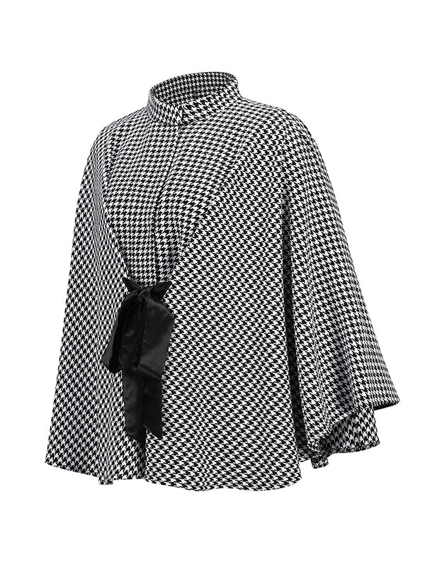 Black and white houndstooth cape coat with a stand collar and tie belt