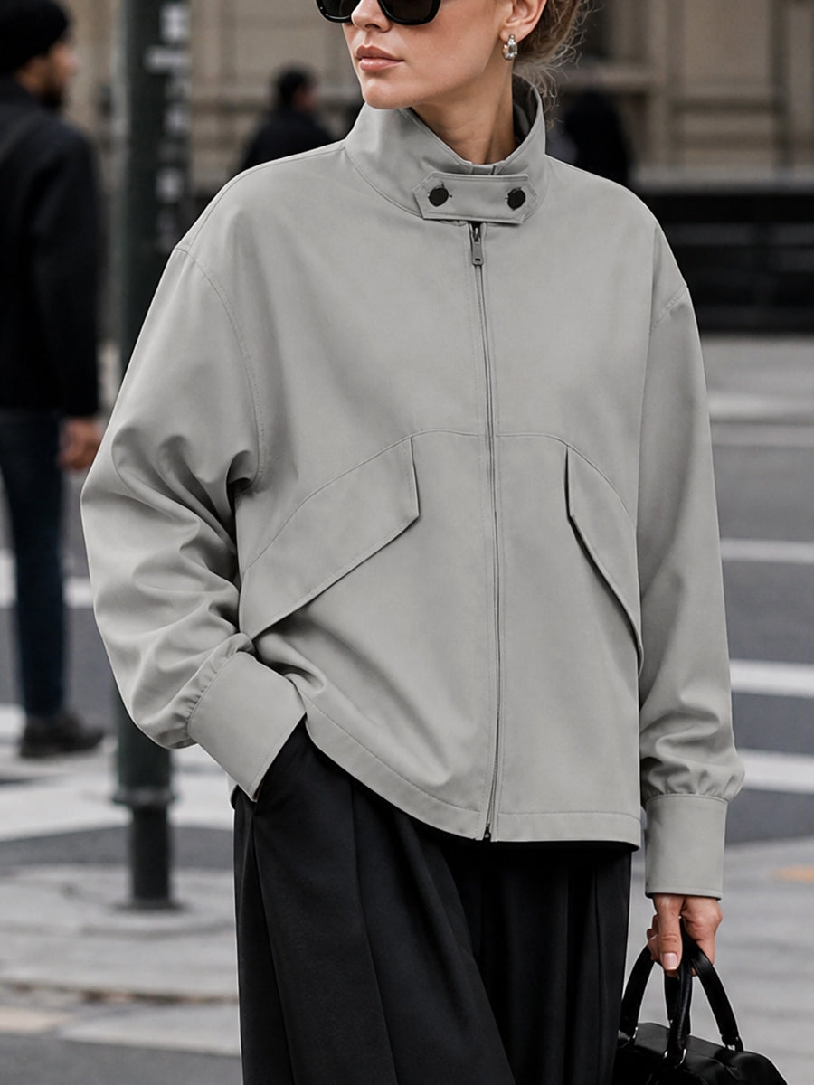 Oversized grey jacket with a high stand collar and zip front