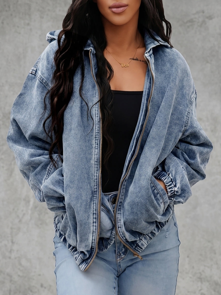 Light wash hooded denim jacket with a zip front and gathered cuffs in light wash