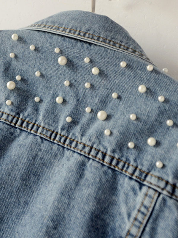 Light wash denim jacket with pearl-effect studs on the shoulders