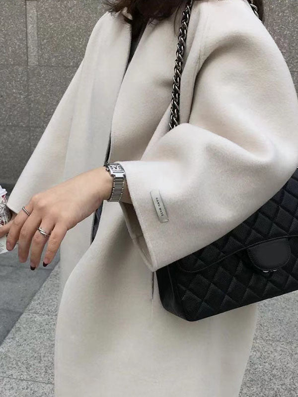 Collarless longline coat with dropped sleeves and an open front in beige