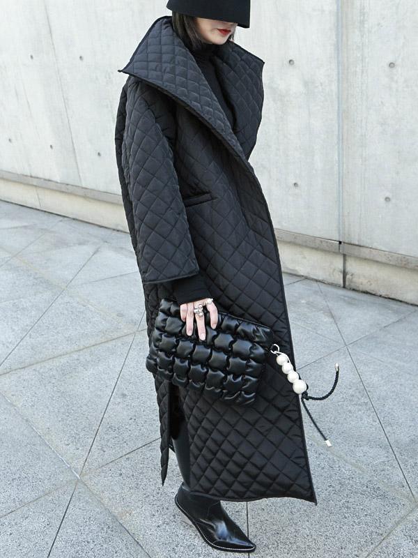 Long black quilted wrap coat with a fold-over collar and ring-buckle belt