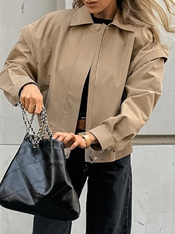Boxy khaki utility jacket with a wide collar and flaps over the shoulder