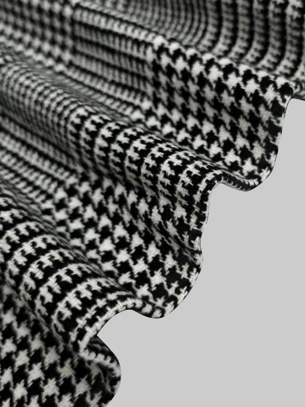 Houndstooth check jacket with an asymmetric front and fold-over collar