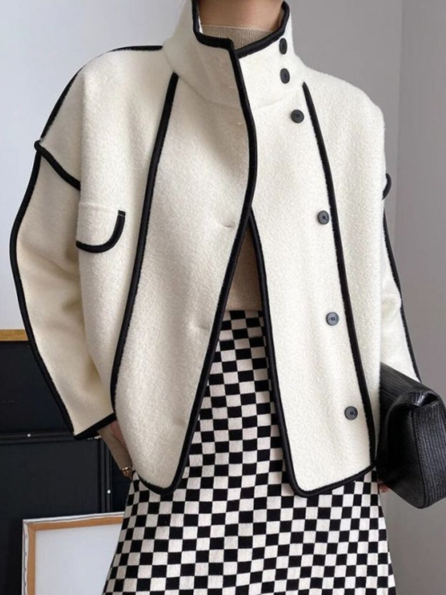 Boxy jacket with contrast piping along the seams and a stand collar in white